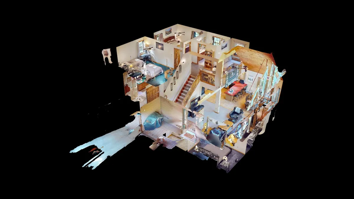 This image captures a vibrant, open-plan living space visible from the staircase, encompassing the living area, kitchen, and dining area. The connected layout shows ample space for families to gather, relax, and share meals together.